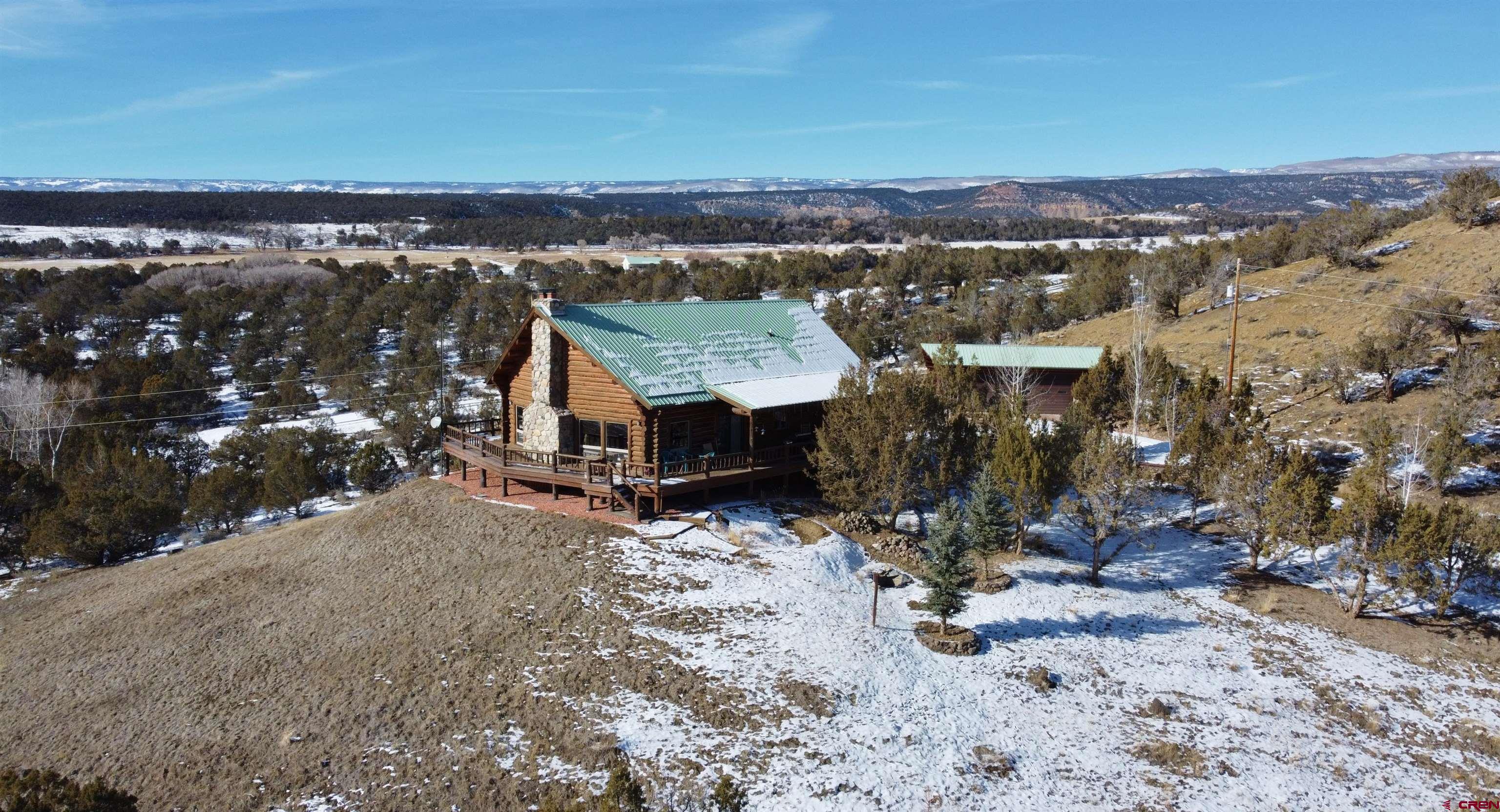 16511 Rimrock Road Cedaredge, CO 81413 - Photo 7 of 35 a view of a house with a yard