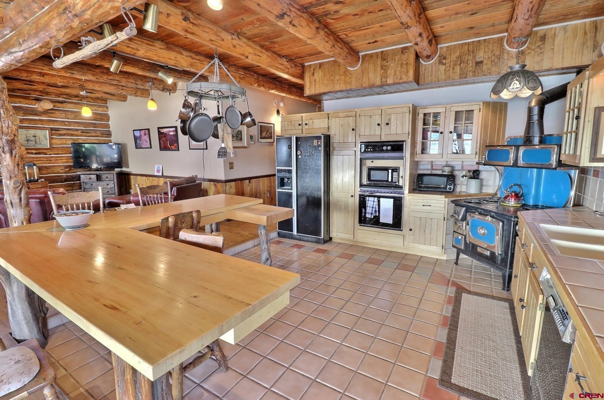 16511 Rimrock Road Cedaredge, CO 81413 - Photo 10 of 35 a room with lots of furniture and a flat screen tv