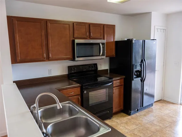 a kitchen with a refrigerator sink and microwave
