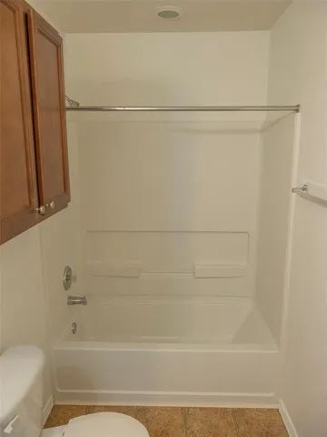 a bathroom with a shower and a toilet