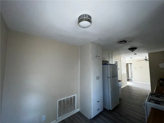 a bathroom with a sink a toilet a mirror and shower