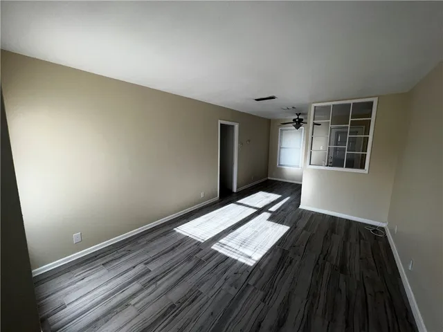 a view of wooden floor in an empty room