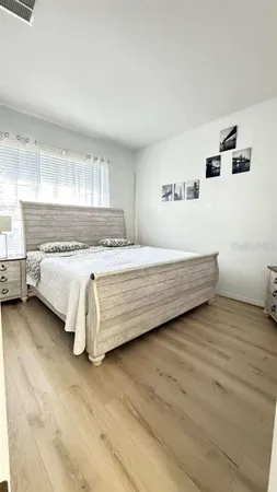 a spacious bedroom with a bed and a window