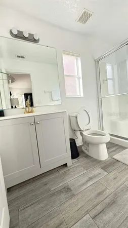 a bathroom with a sink toilet and window