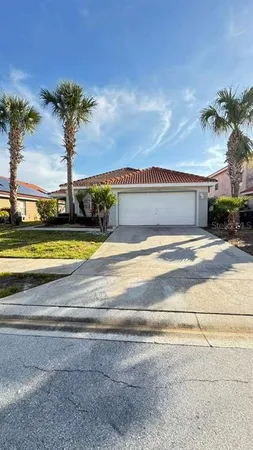 a view of a house with a swimming pool and a yard