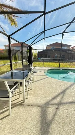 a view of a swimming pool with a patio