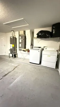 a view of kitchen with stove and white cabinets