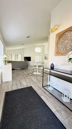 a living room with furniture and wooden floor
