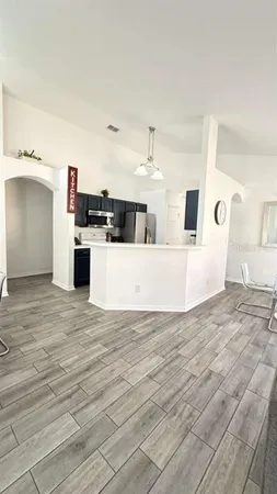 a large white room with kitchen island