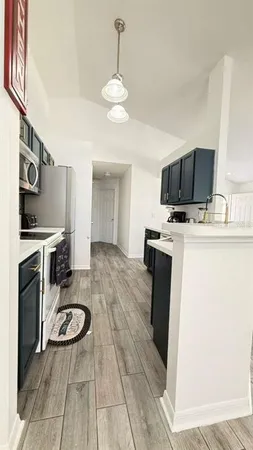 a kitchen with a stove a sink and a refrigerator