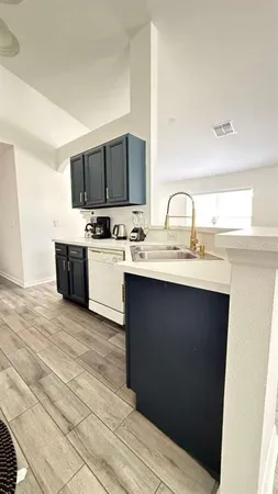 a kitchen with a sink and a stove top oven
