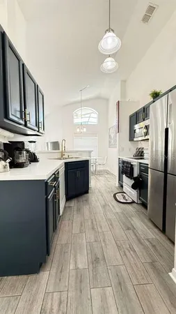 a kitchen with stainless steel appliances granite countertop a sink stove and refrigerator