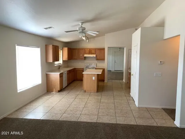 a kitchen with stainless steel appliances a sink and a refrigerator