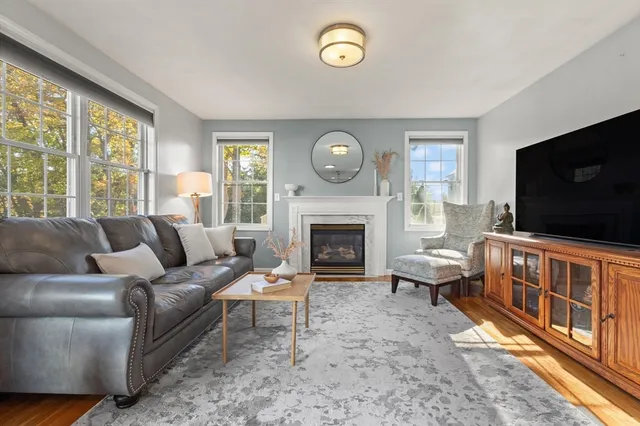 a living room with furniture a flat screen tv and a fireplace