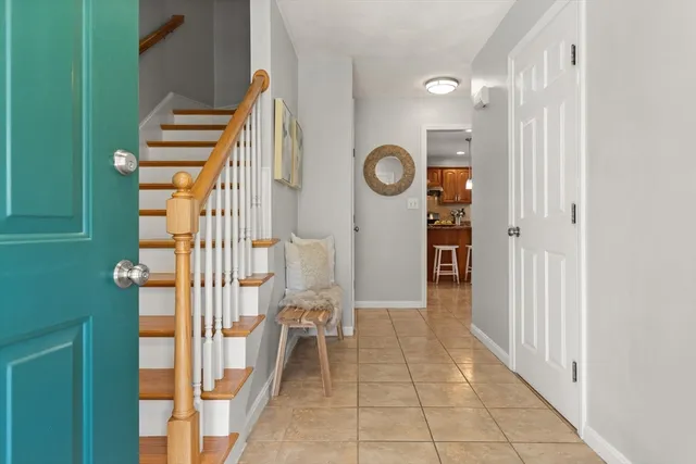 a view of a hallway with wooden floor and entryway