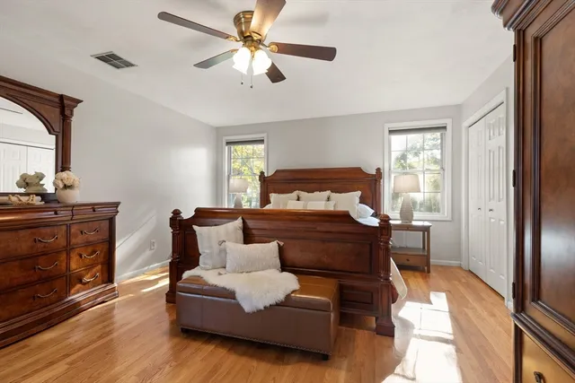 a bedroom with a bed and wooden floor