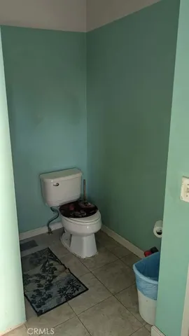 a white toilet sitting next to a small sink