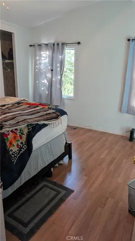 a bed sitting in a bedroom next to a window