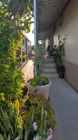 a vase of flowers sitting in front of a house