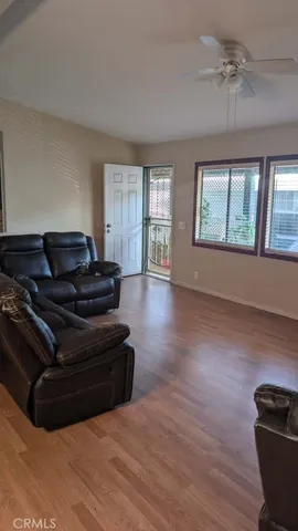 a living room with furniture and a hard wood floor