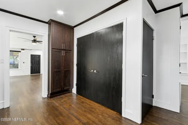 a view of hallway with wooden floor