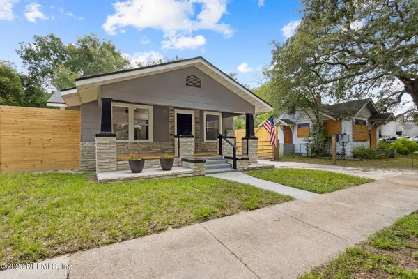 a front view of house with yard and outdoor seating