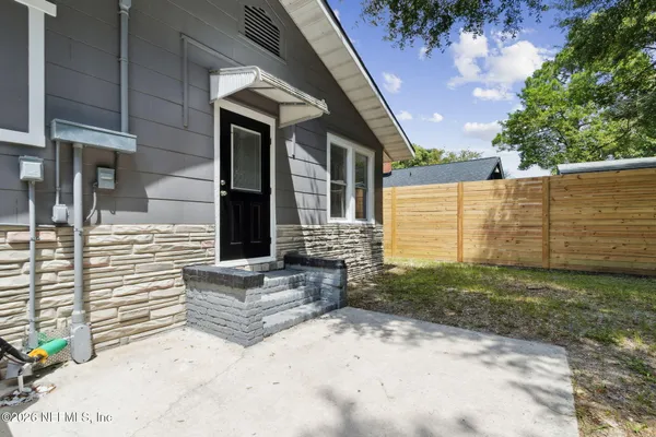 a view of a small house with backyard