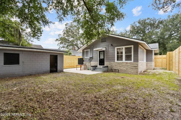 a view of a house with a yard and garage