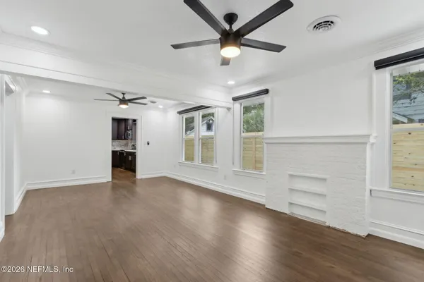 wooden floor in an empty room with a window