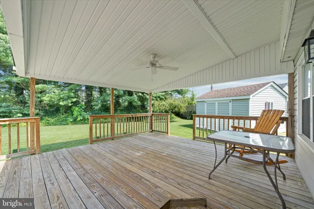 a view of a deck with table and chairs with wooden floor