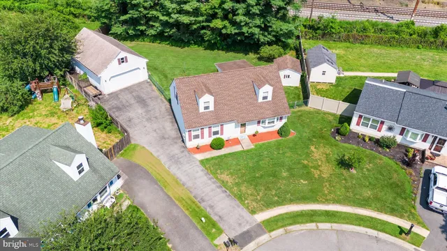 an aerial view of a house with outdoor space and a lake view