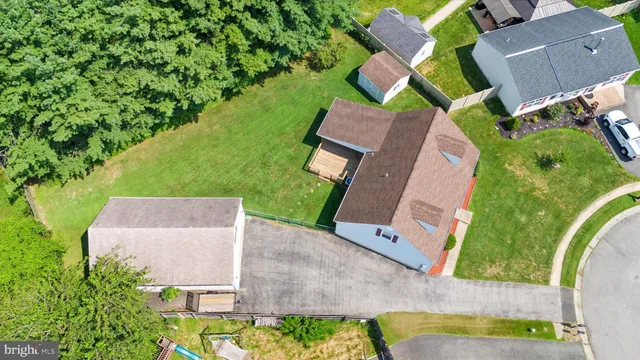 an aerial view of a house with swimming pool and outdoor space