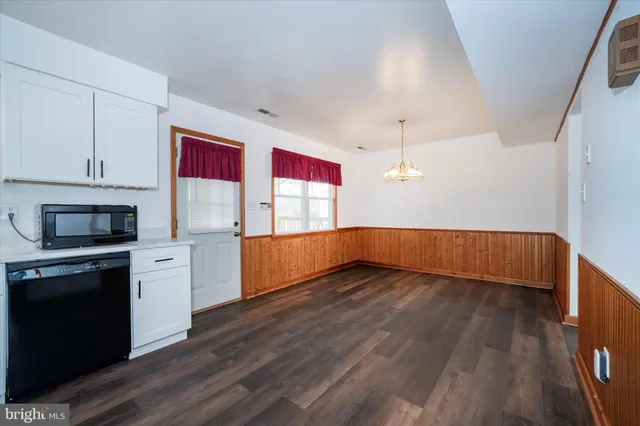 a view of a kitchen with microwave and stove top oven
