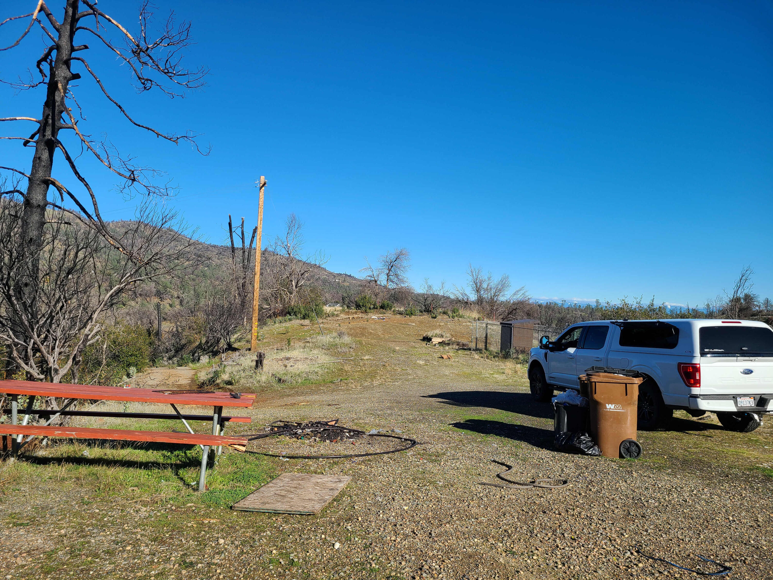 6917 Placer Road Redding, CA 96001 - Photo 19 of 28 a backyard of a house with barbeque oven table and chairs