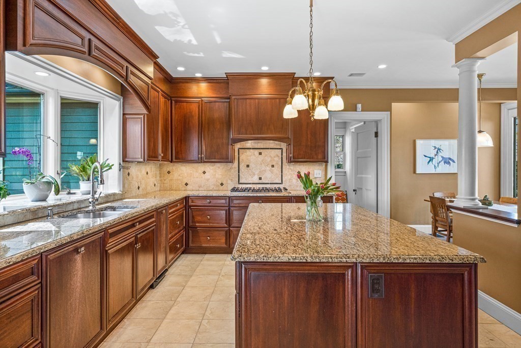 10 Pine Street Winchester, MA 01890 - Photo 11 of 40 a kitchen with kitchen island granite countertop lots of counter top space and stainless steel appliances