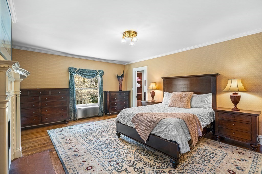 10 Pine Street Winchester, MA 01890 - Photo 21 of 40 a bedroom with a bed and dresser with mirror