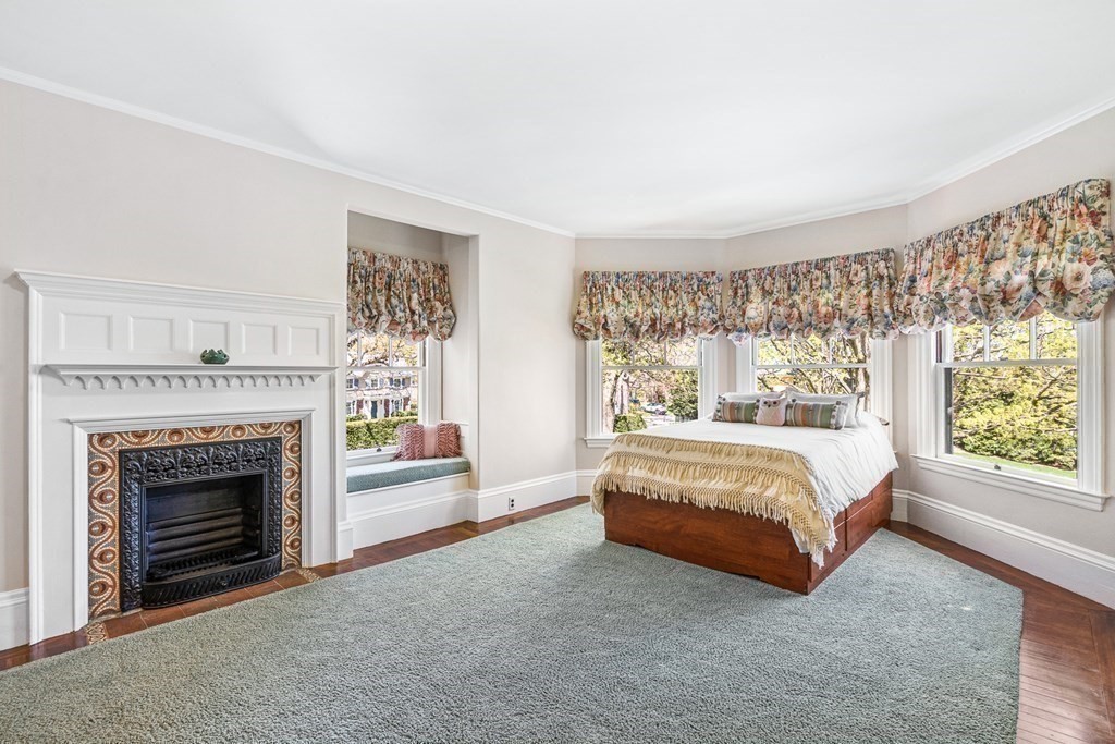 10 Pine Street Winchester, MA 01890 - Photo 26 of 40 a spacious bedroom with a bed and a fireplace