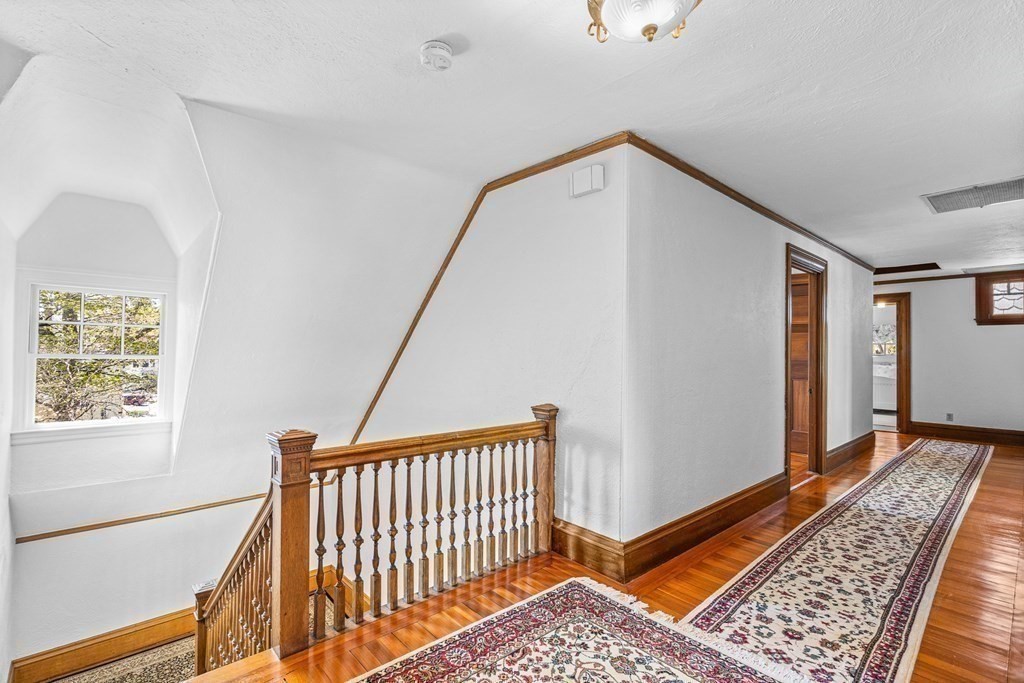 10 Pine Street Winchester, MA 01890 - Photo 30 of 40 a view of a hallway with wooden floor and staircase