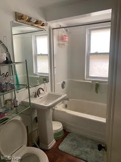 1096 Eddy Road Cleveland, OH 44108 - Photo 3 of 4 Bathroom with a healthy amount of sunlight, toilet, and shower / tub combination