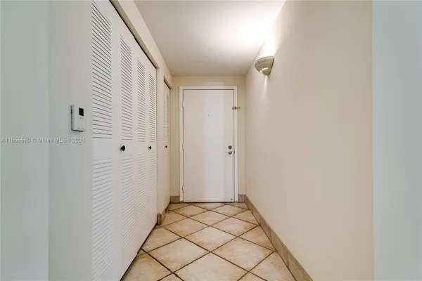 a bedroom with a bed and a flat tv screen on a dresser