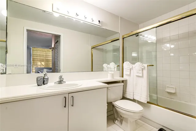 a bathroom with a sink mirror and a shower