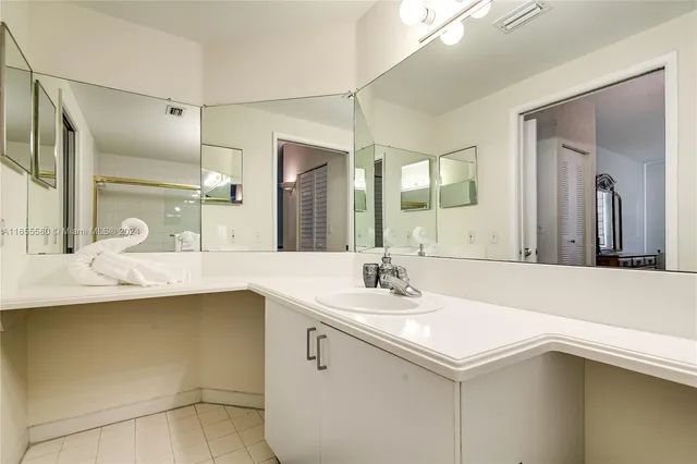 a bedroom with a bed and a baby crib next to a window