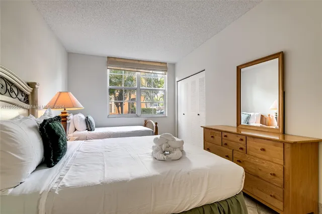 a bedroom with a bed and a large window