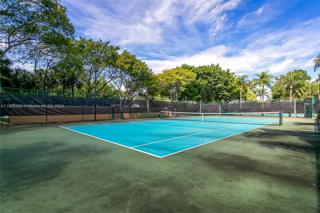 a kitchen with a table chairs refrigerator and cabinets