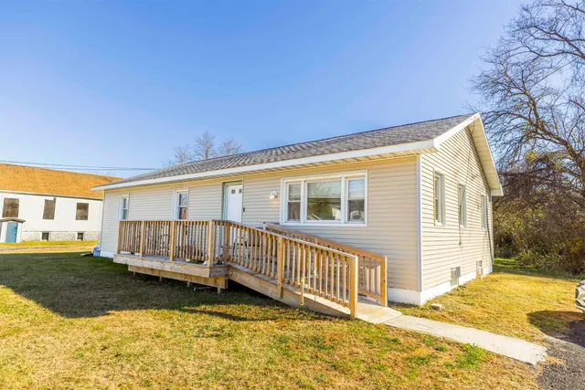 a view of a house with wooden fence
