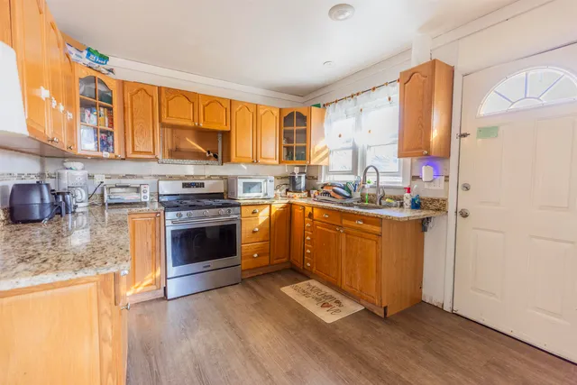 a kitchen with stainless steel appliances granite countertop a stove a sink dishwasher and a refrigerator