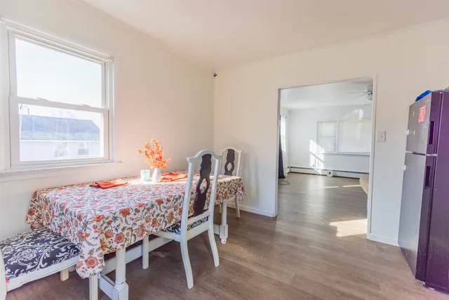 a bedroom with a bed and a table with wooden floor