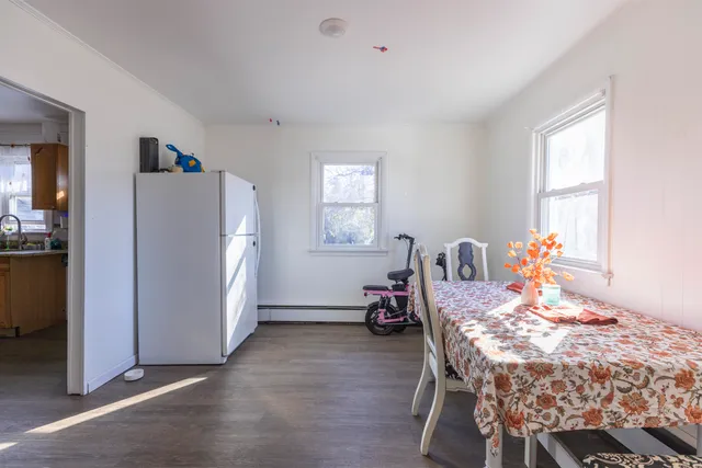 a dining room with furniture and window