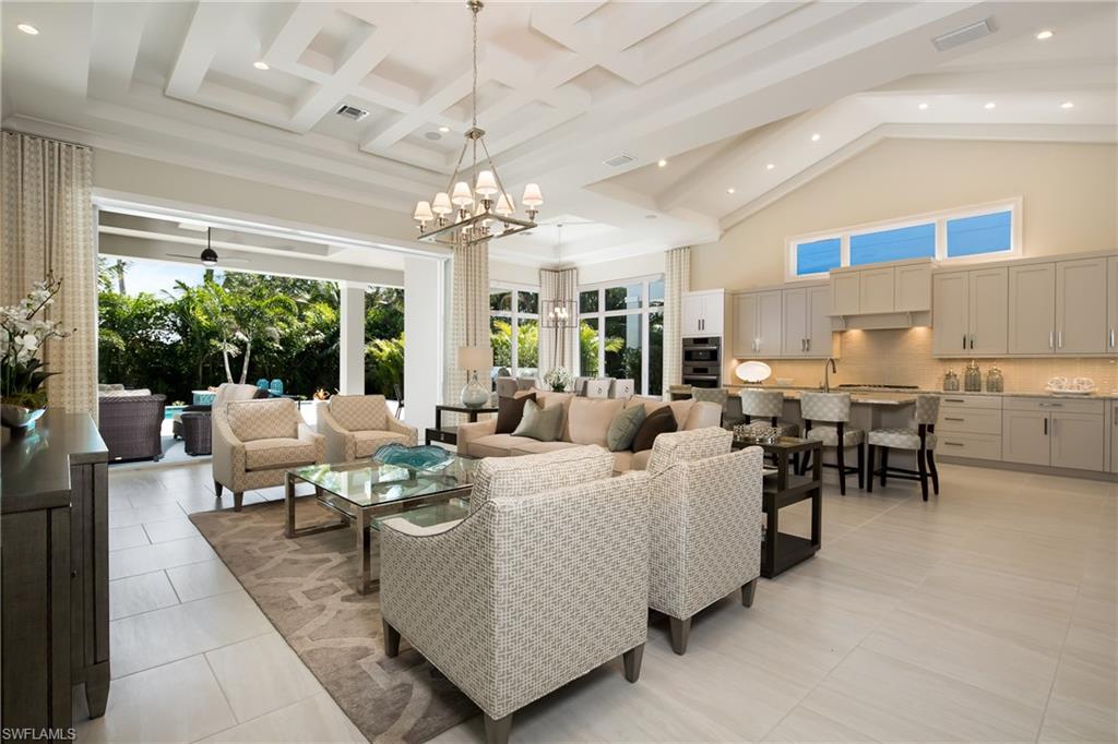 6818 Mangrove Avenue Naples, FL 34109 - Photo 12 of 24 a living room with furniture and a large window