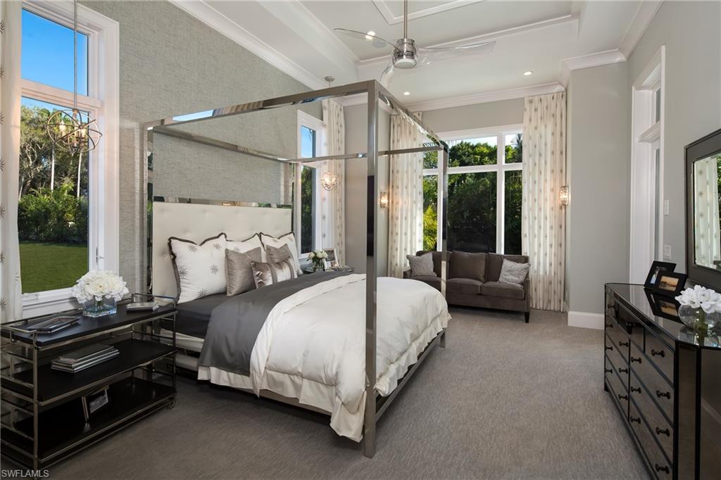 6818 Mangrove Avenue Naples, FL 34109 - Photo 14 of 24 a spacious bedroom with a bed couch and a window